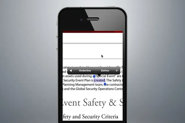 Phone mockup of a document with one word selected, blue drag handles at each end and a small black menu above it offering Underline and Define.