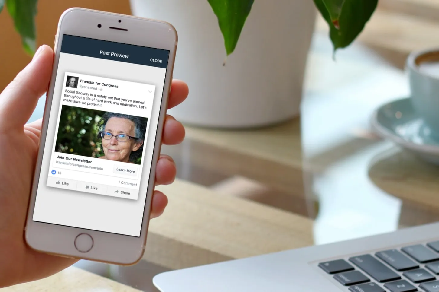 Phone held in a hand showing a Post Preview screen with a sponsored social media post for a congressional campaign, a portrait photo, a newsletter link and a Learn More button.