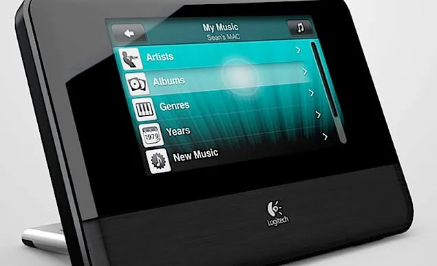 Squeezebox Touch device at an angle, its screen showing the My Music menu with Artists, Albums, Genres, Years and New Music rows.
