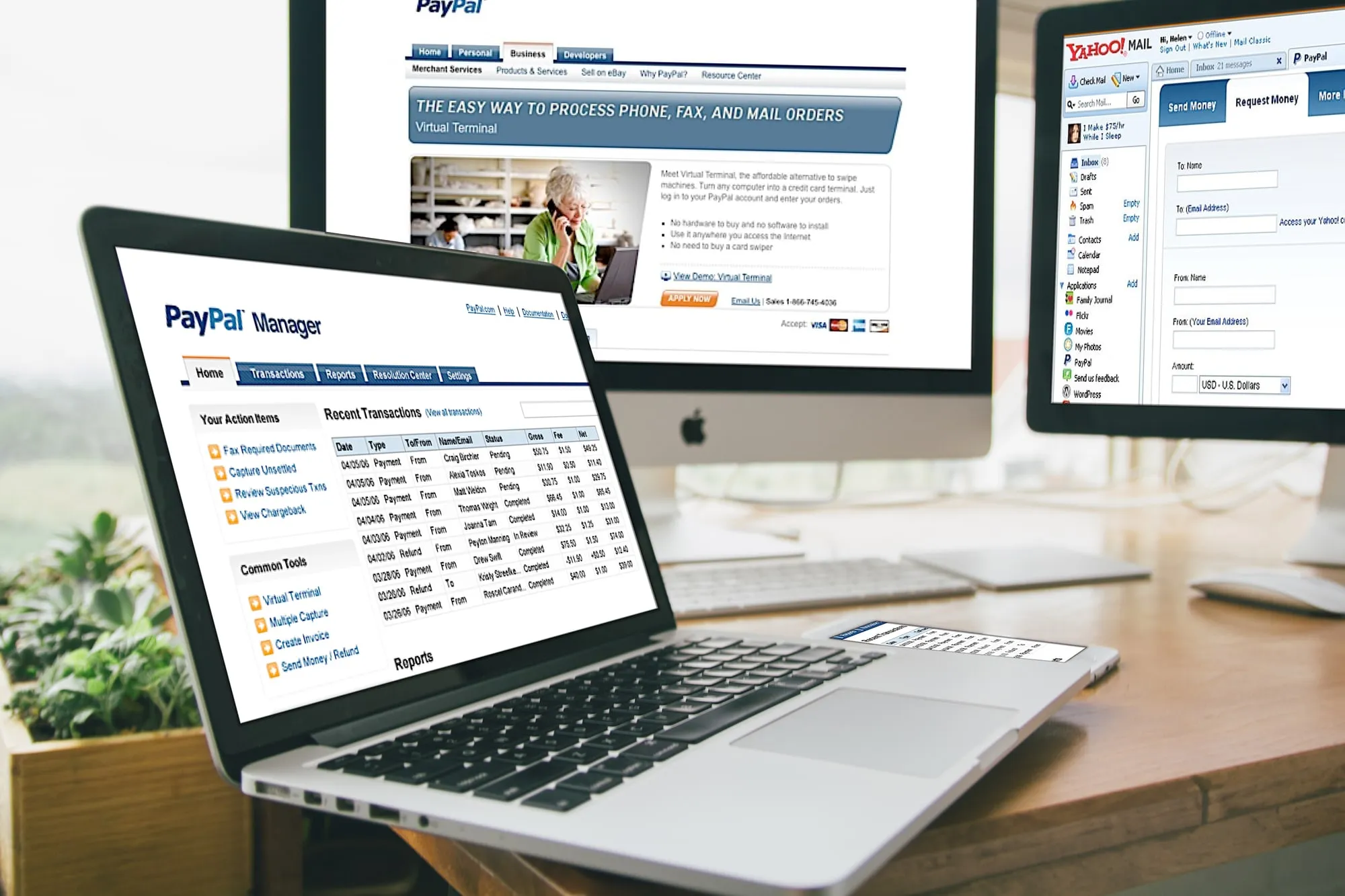 A laptop showing the PayPal Manager home screen, in front of a monitor with the Virtual Terminal page and a second monitor with the Request Money form in Yahoo Mail.