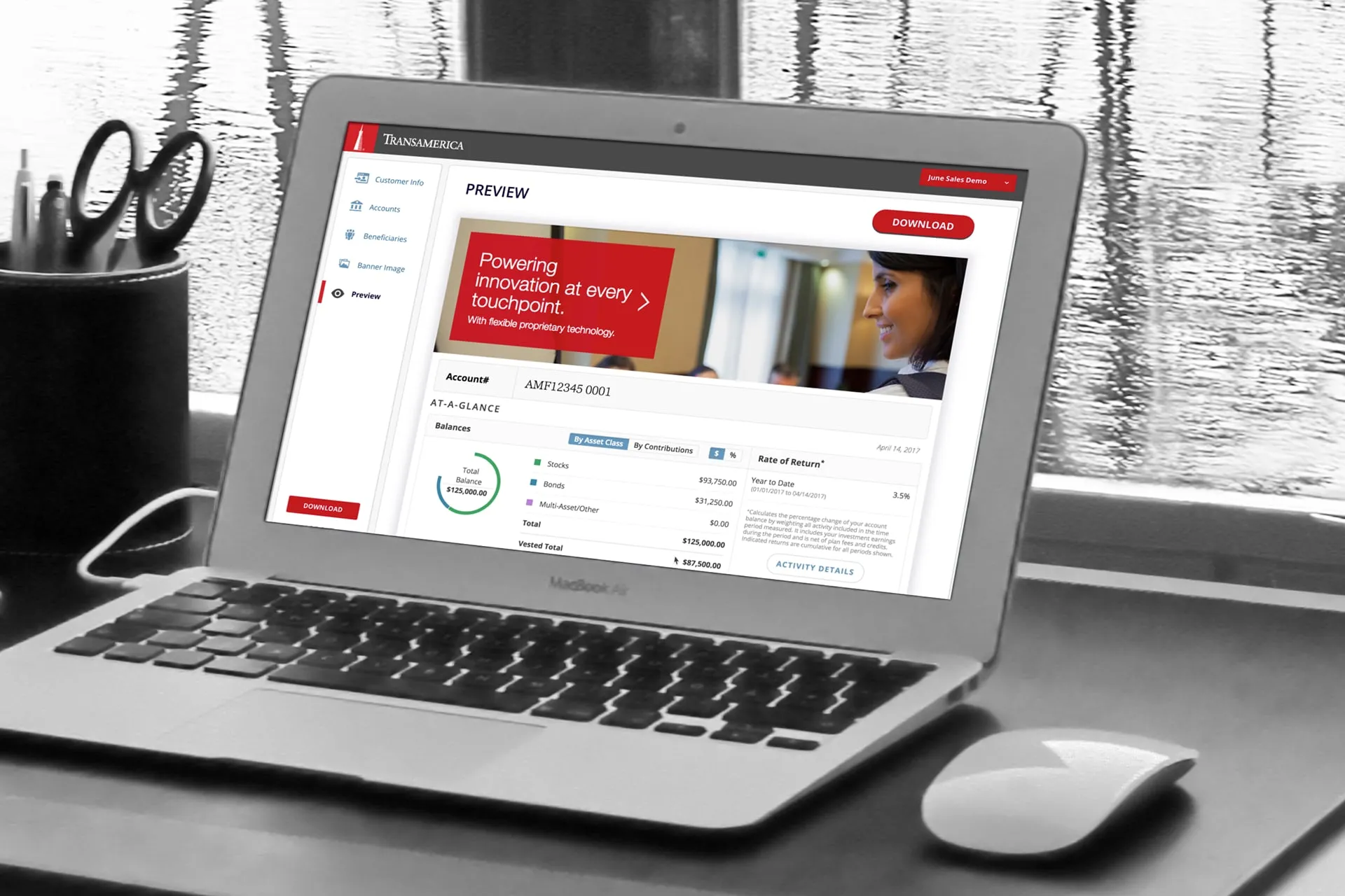 Laptop on a desk showing a Transamerica account dashboard preview with a banner, account number, balances by asset class, rate of return and a red Download button.